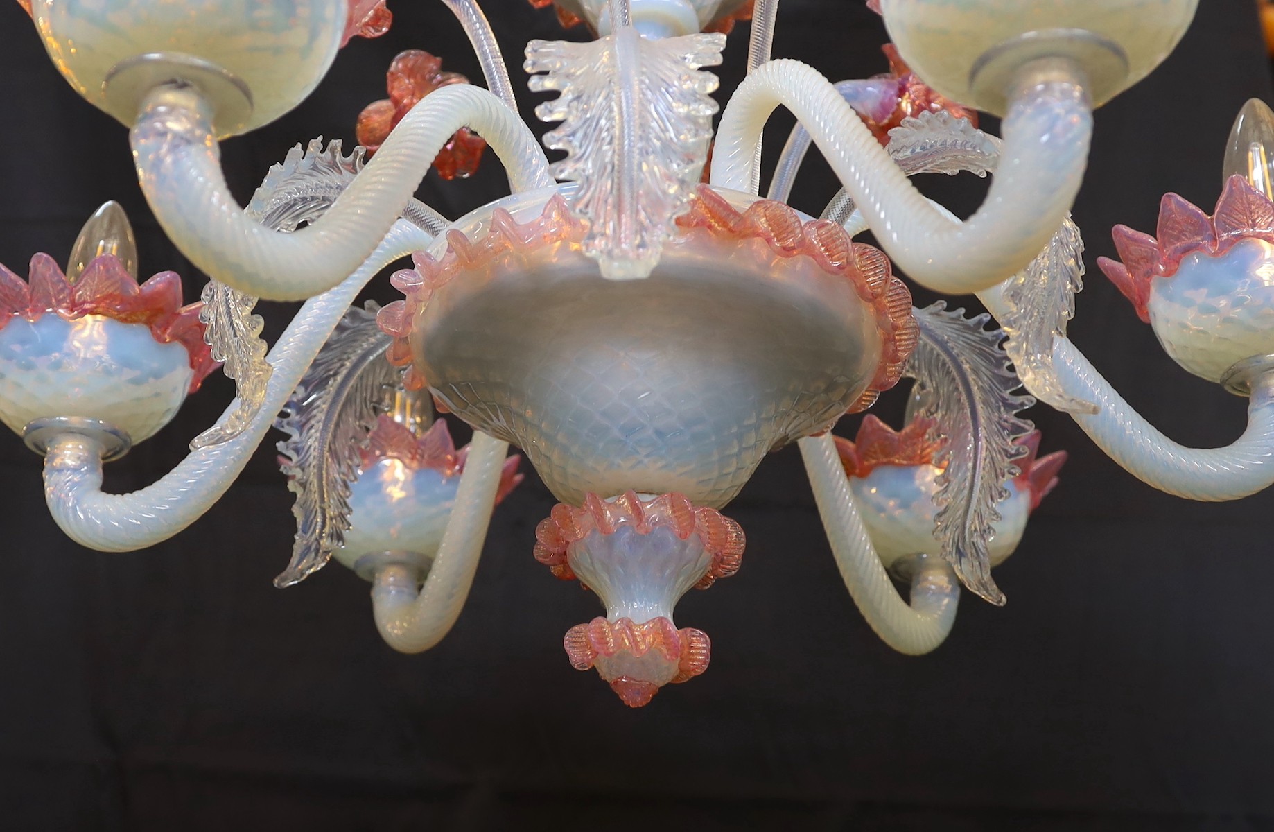 A 1950s Venetian pink and Vaseline glass six light chandelier with ornate flower and leaf motifs, height 90cm. width 70cm